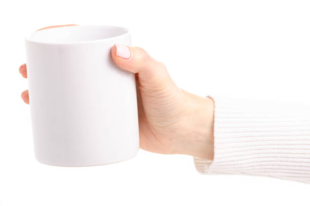 istock White cup mug in female hand 1087597526
