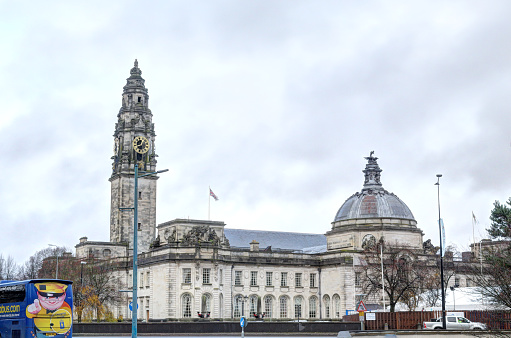 Cardiff, United Kingdom - December 01, 2018: The 18th century Cardiff City Hall, with bell tower and dome, during a cloudy winter day, United Kingdom