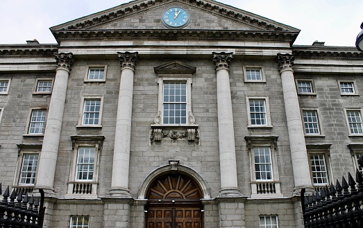 Dublin, Ireland - March 31, 2018: Trinity College is considered one of the world's most prestigious academic institutions in the world. The college was first founded by Queen Elizabeth 1 in the year 1592. However, women were not admitted as full-time students until January of 1904. Arguably the most famous building of the campus is the Library of Trinity College which includes significant quantities of manuscripts, including the Book of Kells.