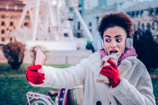 istock Emotional female person taking photo while eating 1087616970