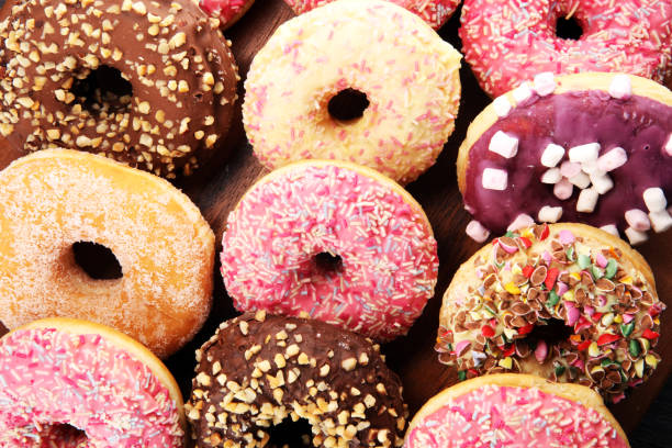 istock assorted donuts with chocolate frosted, pink glazed and sprinkles donuts 1087617798
