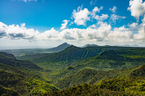 Aerial view over tropical Black River Gorges National Park Mountain Range on Mauritius Island under blue summer sky.  Black River Gorges Scenic View, Mauritius, Africa.