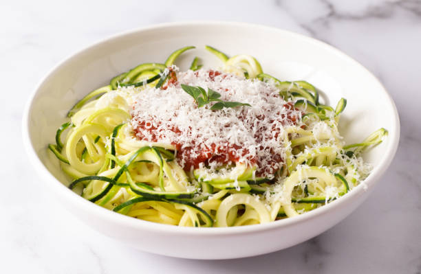 istock Zucchini Pasta Topped with Parmesean Cheese and Tomato Sauce 1087624954