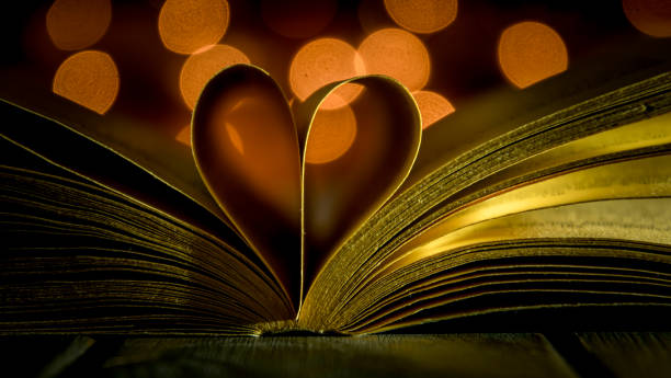istock Old book and festive light bulbs. Valentine's Day Vintage Card 1087626832