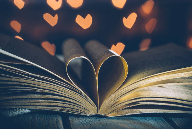 istock Old book and festive light bulbs. Valentine's Day Vintage Card 1087626848