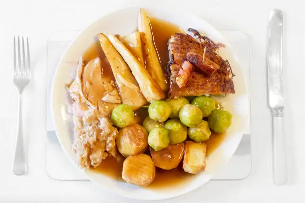 Christmas dinner plate roast turkey parsnips potatoes sprouts stuffing and graving uk