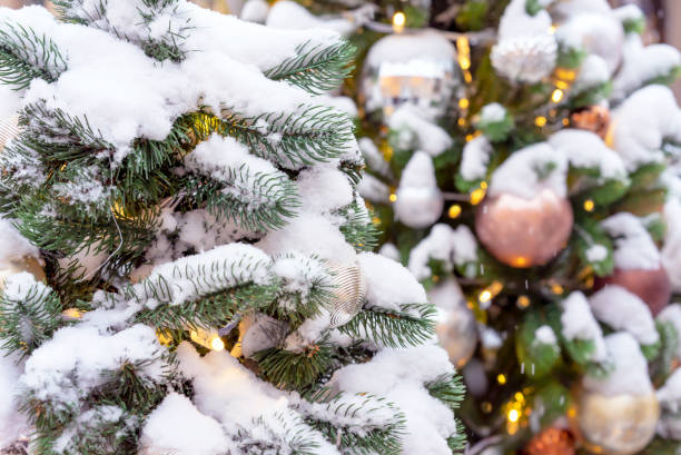 istock Snow-covered Christmas tree with toys and a garland. 1087634164