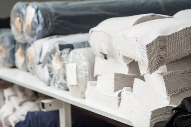 istock Textile blanks and rolls of cloth lie on the shelves 1087636554