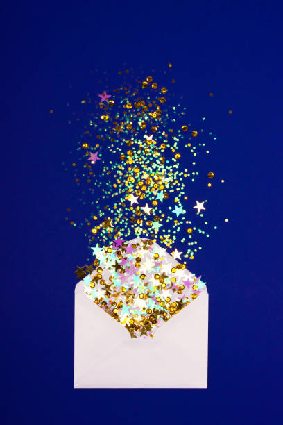 istock Colorful confetti scattered from envelope on blue background. 1087648894