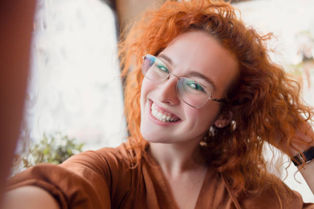 istock Young redhead take selfie on smartphone 1087650302