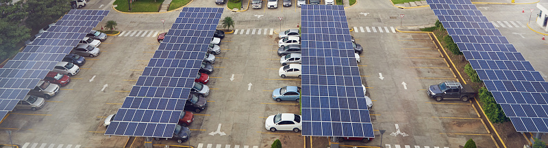 Parking lot with solar panel on roof aerial above view