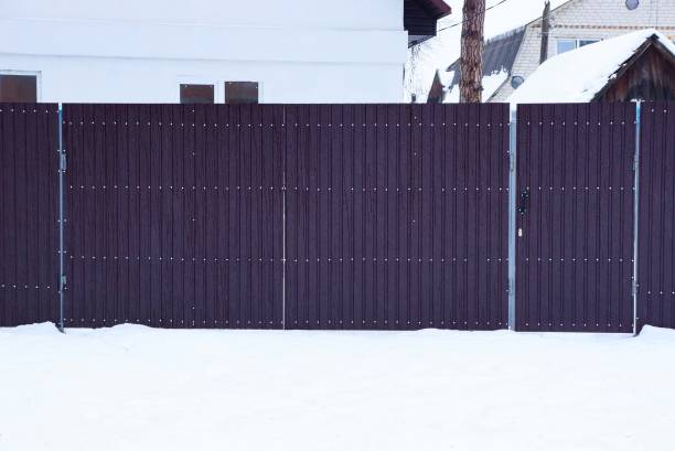 istock long brown metal gate outside in white snow 1087652722