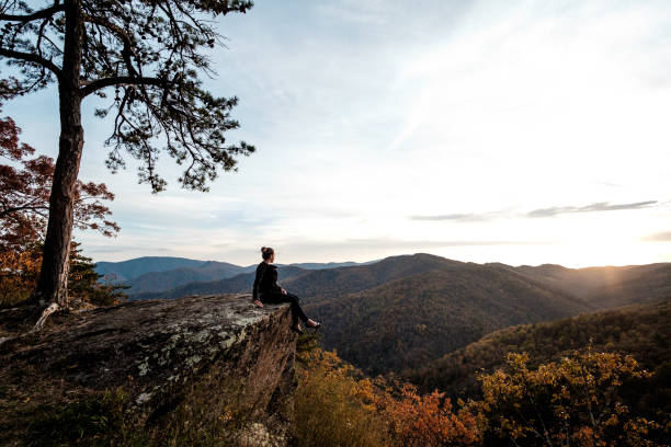 Woman sitting on a landscape of Skyline Drive - Virginia - USA Woman sitting on a landscape of Skyline Drive - Virginia - USA skyline drive virginia photos stock pictures, royalty-free photos & images