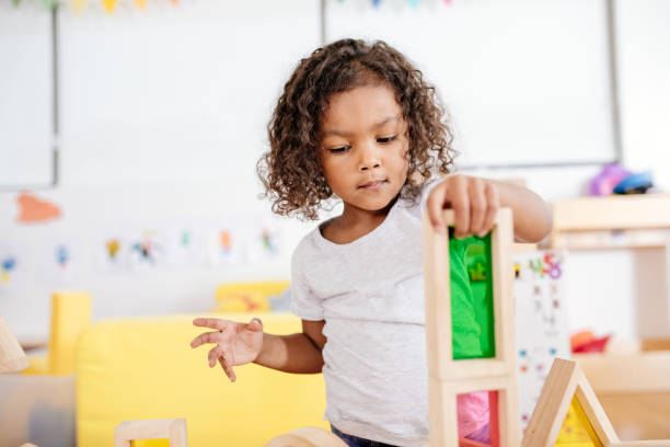 istock Toddler counting blocks in kindergarten 1087664548