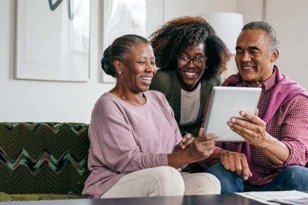 istock Grandparents and their daughter with tablet 1087664604