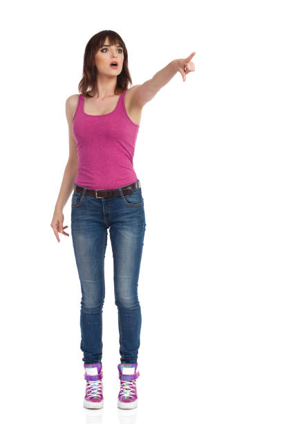 istock Curious Young Woman Is Looking Away And Pointing 1087665054