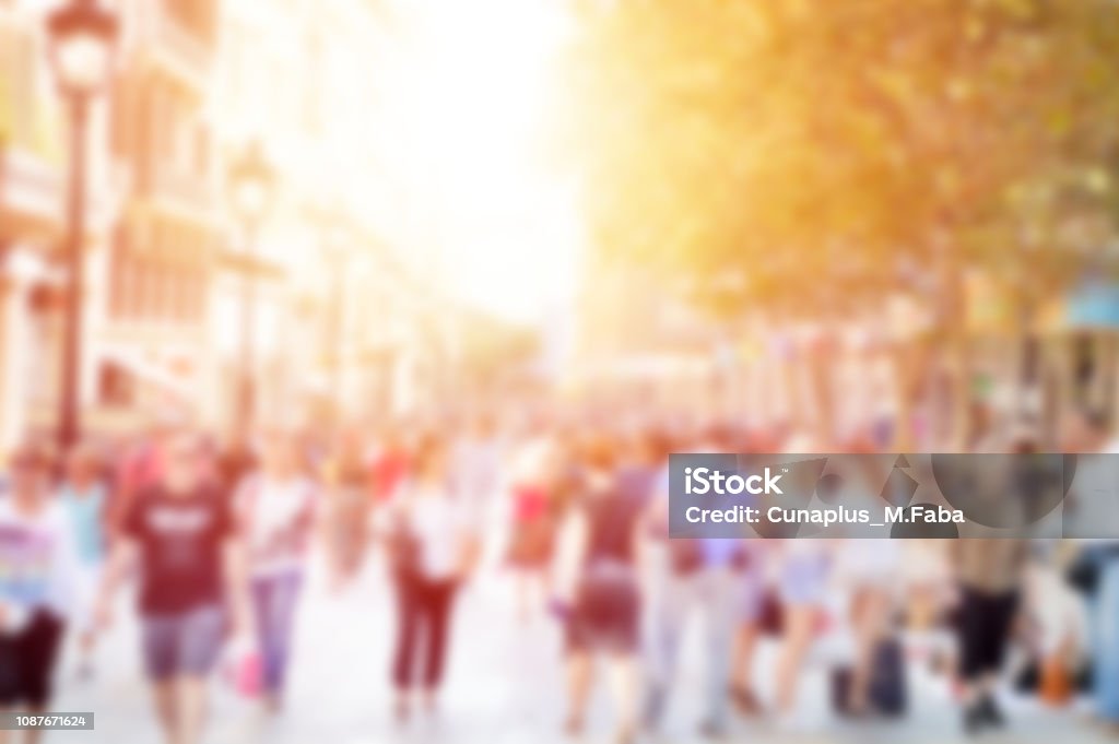 defocused street Blurred background. Blurred people walking through a city street Customer Stock Photo