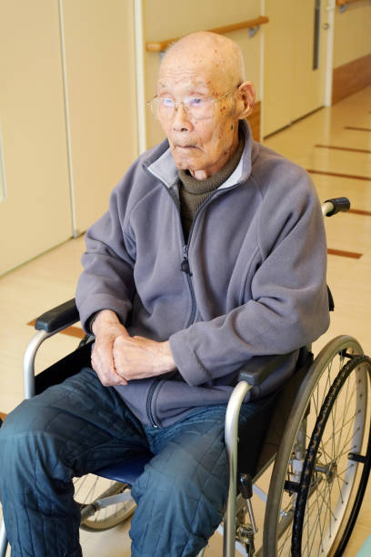 istock elderly man on wheelchair in nursing home 1087673078