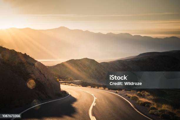Highway At Sunrise Going Into Death Valley National Park Stock Photo - Download Image Now