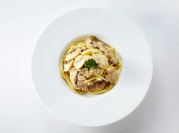 istock Delicious mushroom spaghetti on a white background 1087680332