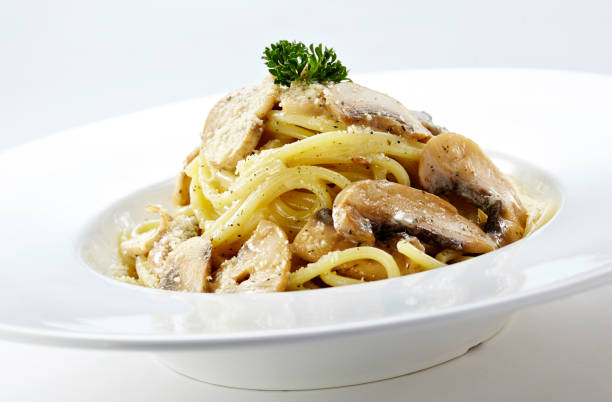istock Delicious mushroom spaghetti on a white background 1087680334