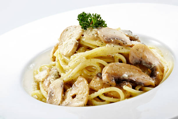 istock Delicious mushroom spaghetti on a white background 1087680352