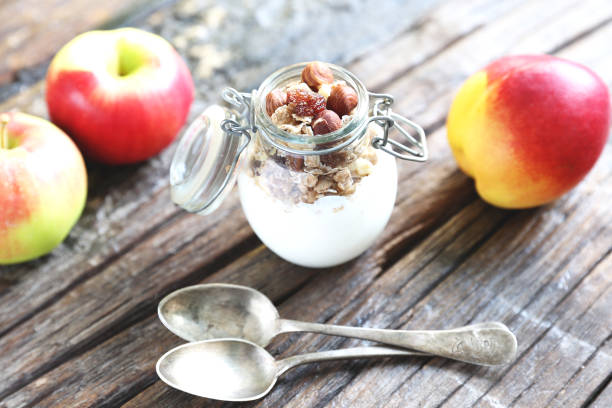 istock Glass jar with yogurt, granolla and almond nuts in it. 1087681930