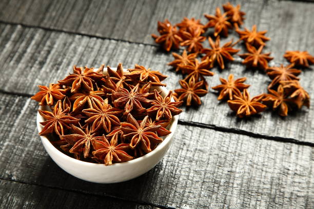 Indian spices- organic star anise Background of Indian exotic spice- star anise star anise stock pictures, royalty-free photos & images