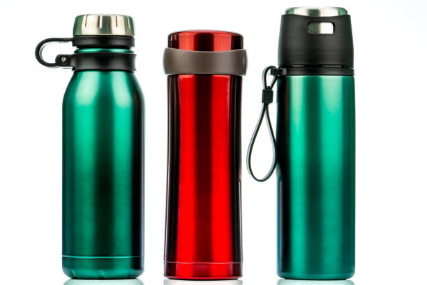 Thermos bottle isolated on white background. Coffee or tea reusable bottle container. Thermos travel tumbler. Insulated drink container. Red and green stainless steel thermos water flask. Zero waste.