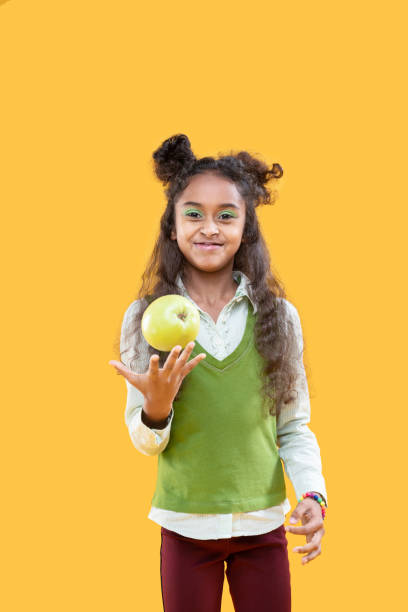 istock Delighted happy girl holding a green apple 1087713692
