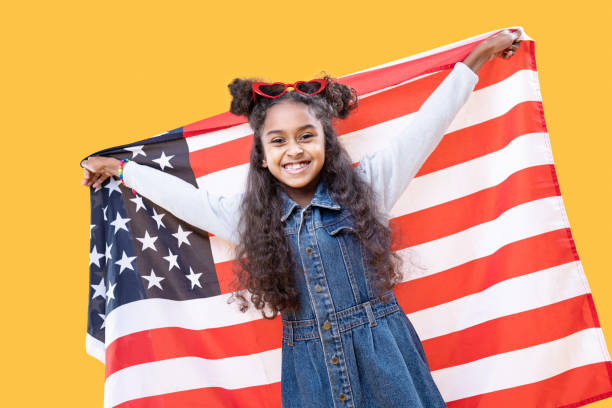 istock Cheerful delighted girl holding up a US flag 1087713720