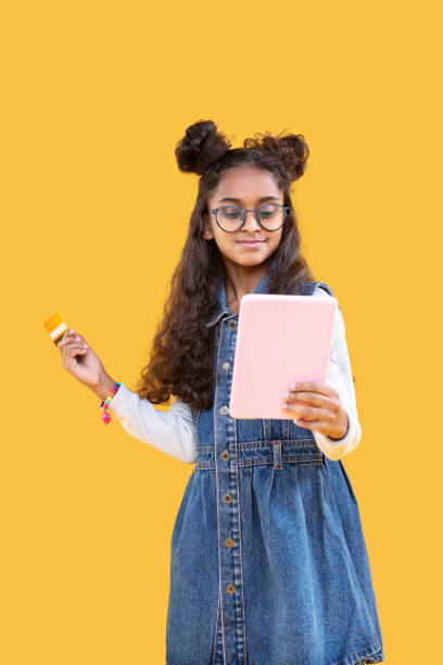 istock Positive smart young girl doing shopping online 1087713866