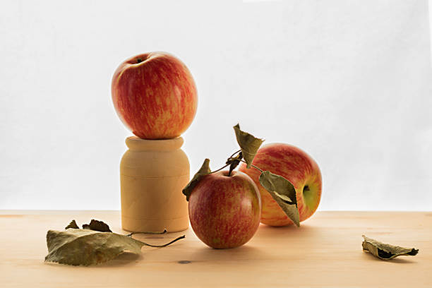 istock red apple on wooden table on the white background 1087734094