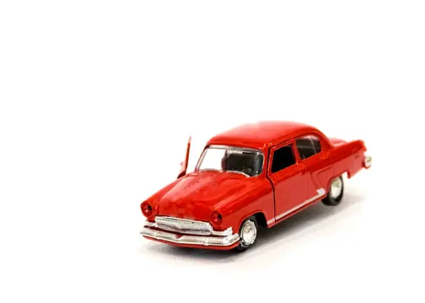 Photo of beautiful little red toy car on a white background