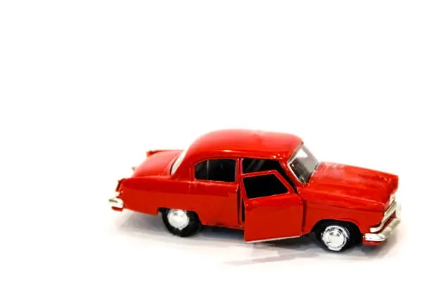Photo of beautiful little red toy car on a white background