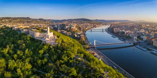 Budapest, Hungary - Aerial panoramic skyline view of Budapest at sunrise. This view includes the Statue of Liberty, Elisabeth Bridge and Szechenyi Chain Bridge with blue sky