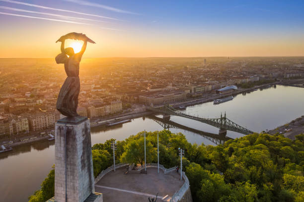 Budapest, Hungary - Aerial view of the beautiful Hungarian Statue of Liberty with Liberty Bridge and skyline of Budapest at sunrise stock photo