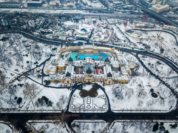 Budapest, Hungary - Aerial view of the famous Szechenyi Thermal bath from above in the snowy City Park stock photo