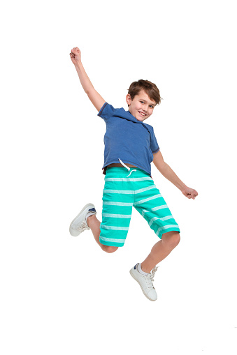 A boy jumping on a trampoline, seeming to fly.