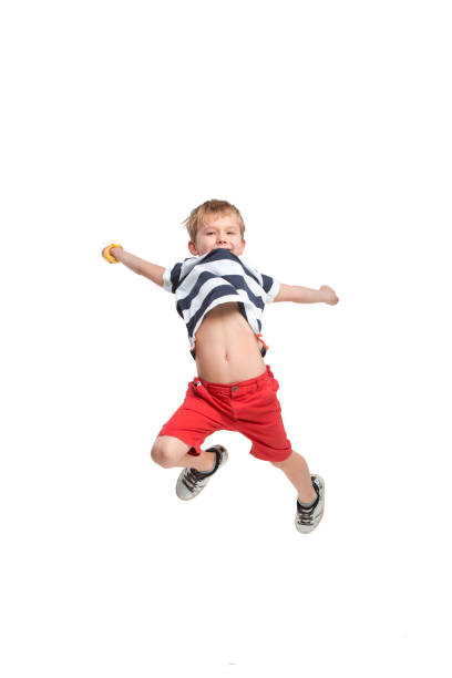 istock Adorable boy jumping and raises his hands up. 1087756252