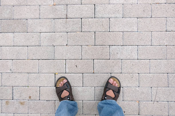 istock Man legs on gray brick blocks floor 1087767830