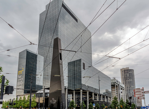 Rotterdam, Netherlands - May 22, 2018: Modern and majestic Gebouw Delftse Poort (Delft Gate Building) office skyscraper with facade made of maintenance free, blue coloured reflective glass.