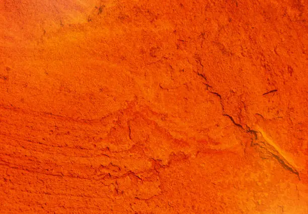 Photo of natural texture of a cracked red ocher wall