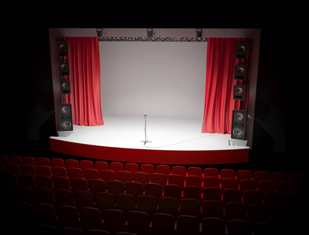 istock Concert hall with a red curtain and a microphone on the counter. 1087781798