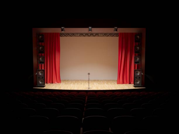 istock Concert hall with a red curtain and a microphone on the counter. 1087781804