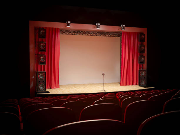 Concert hall with a red curtain and a microphone on the counter. Concert hall with a red curtain and a microphone on the counter. 3d illustration comedian stock pictures, royalty-free photos & images