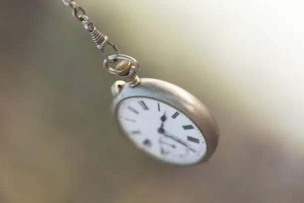 Pocket clock swings like the inexorable flow of time