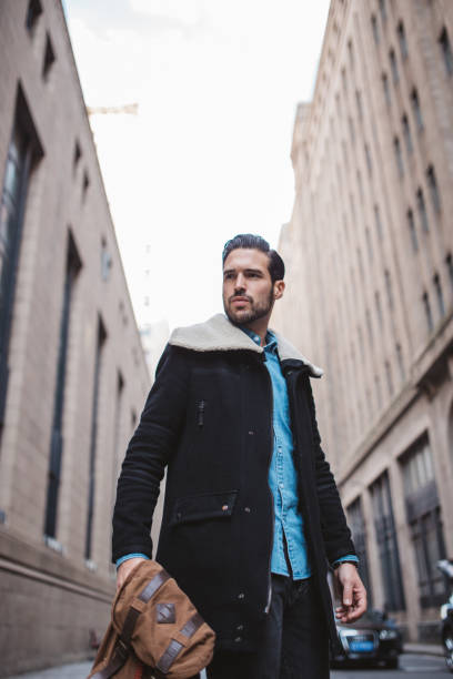 istock Guy with backpack walking on the street 1087792844