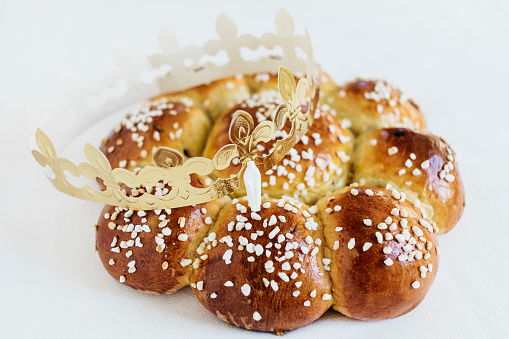 King Cake or King Bread, called in German language Dreikönigskuchen, baked in Switzerland on January 6th, to celebrate the festival of Epiphany at the end of the Christmas season. Small plastic miniature of the king is hidden inside of the bread. The person who finds it, is called the king of the  day.