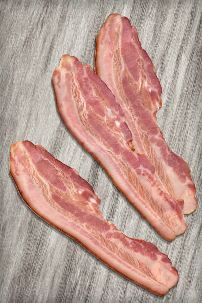 istock Three Pork Bacon Rashers Set On Bleached Wood Background 1087803726